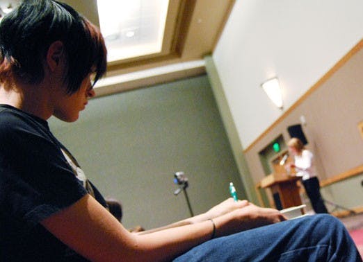 Chris Sherlin takes notes during economist Loretta Napoleoni's lecture on the global financial crisis Monday at the SUB.  