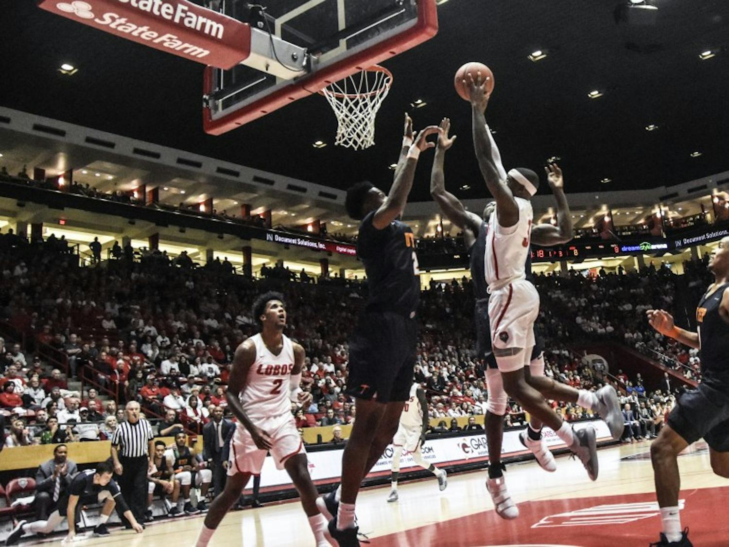 Keith McGee shoots into the air as he attempts to score for UNM this past Saturday. UNM won against UTEP 84-78.