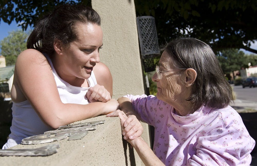 	Veronica Navigato, left, and Madeleine Dorado chat in the National Historic Spruce Park Neighborhood, west of campus, on Wednesday. The two live across from each other in the neighborhood and have lived there for over 10 years. Both are concerned about traffic from the expanding University. 
