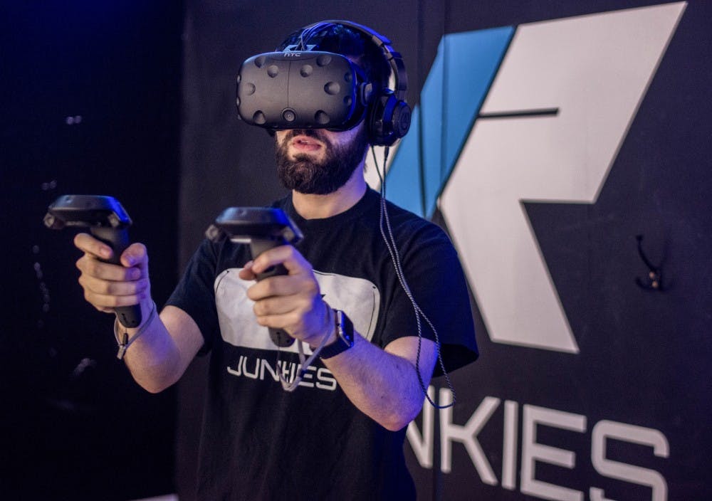 Ben Ginsburg demos the HTC Vive virtual reality headset at VR Junkies, Friday, July, 14. VR Junkies is a virtual reality arcade and storefront that immerses guests into the developing worlds of VR software and hardware. The space boasts 60+ software titles that utilize various VR setups. 