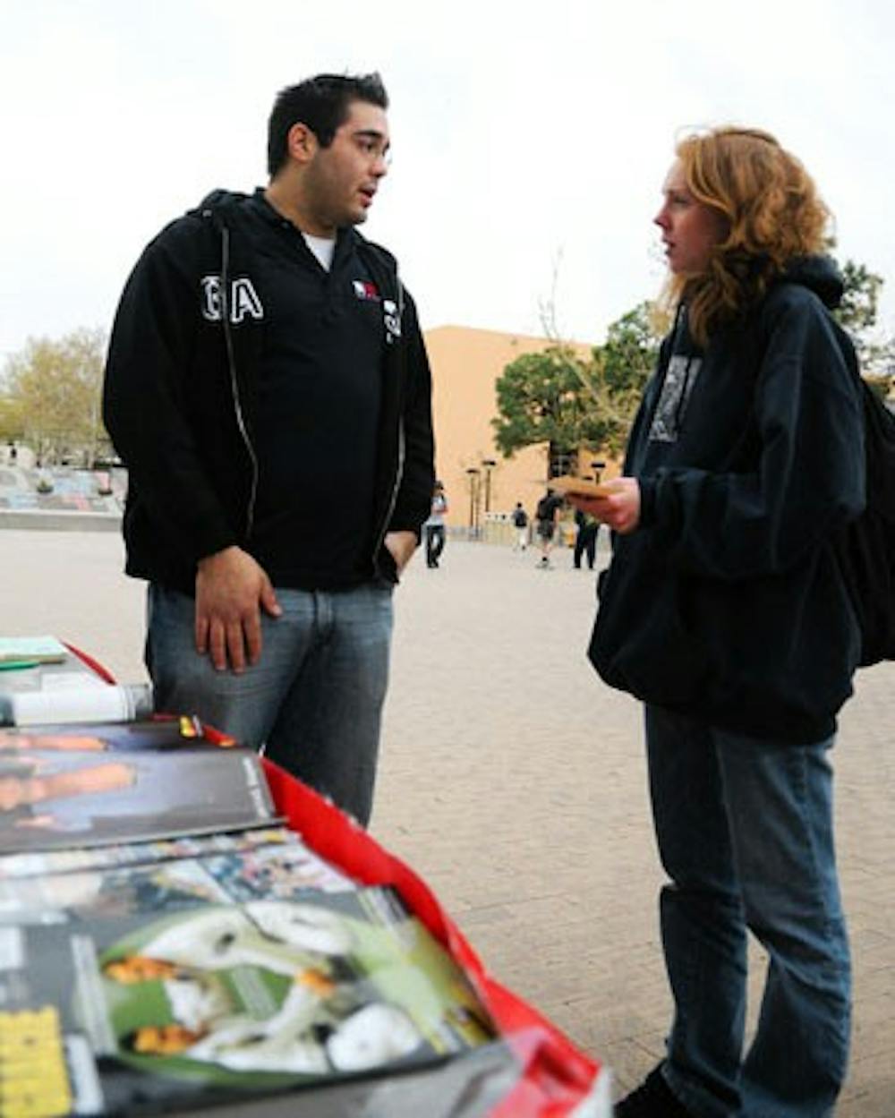 Michelle Barrett, right, talks to Brazilian Jujitsu representative Marcus Gonzales about self-defense techniques during Sexual Assault Awareness Day on Wednesday in Smith Plaza.