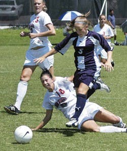 Lobo defender Krista Peterson slide-tackles Fort Lewis' Lorin Anderson during UNM's 3-0 exhibition game win Thursday at the newly renovated Robertson Training Facility.