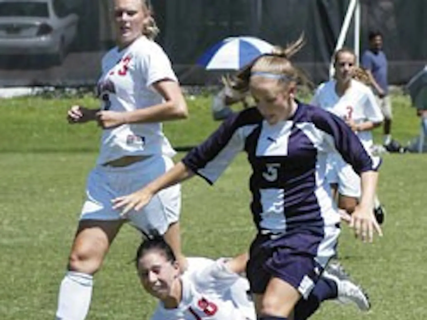 Lobo defender Krista Peterson slide-tackles Fort Lewis' Lorin Anderson during UNM's 3-0 exhibition game win Thursday at the newly renovated Robertson Training Facility.