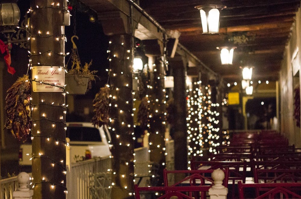 Businesses get ready for the holidays in Old Town Albuquerque on Monday night. Luminaria tours will be given in the weeks to come.