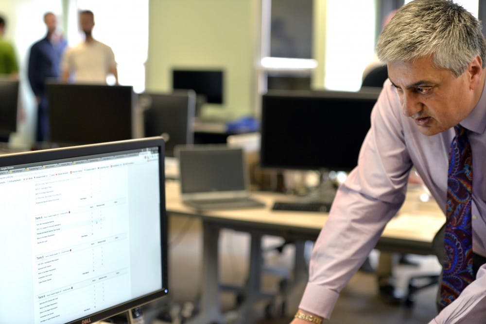 UNM Provost and Executive Vice President for Academic Affairs Chaouki Abdallah scans through new modules created by the Institute for Design and Innovation. These new systems are geared to help students achieve their academic goals through intensive analytic analysis.&nbsp;