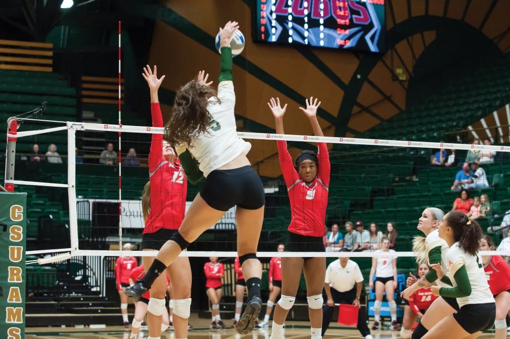 Lobos Cassie House (12) and Simone Henderson (9) leap to block a CSU players spike during their game October 3. The Lobos lost their two games on the roade this week against Colorado State and Wyoming State. 