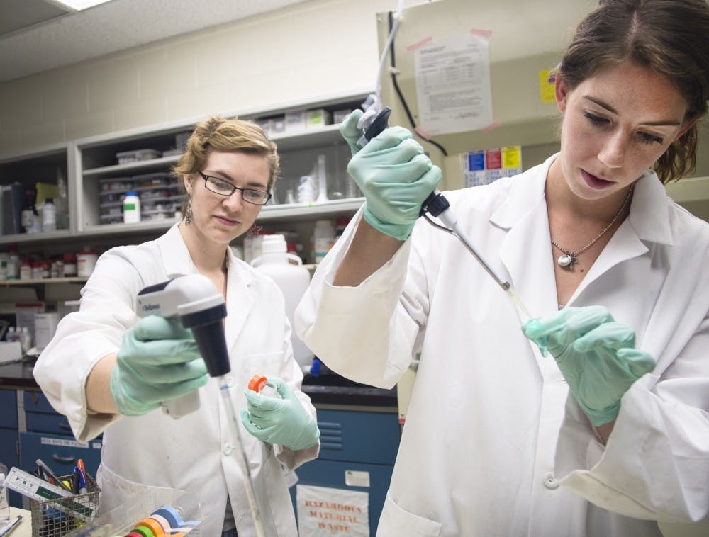 	Kristin Marquardt, left, and Lauren Topper work in the laboratory of Fernando Valenzuela, professor of neurosciences and associate director of the New Mexico Alcohol Research Center, on Thursday. The center at UNM is nationally recognized for Fetal Alcohol Spectrum Disorder research and is funded through various grants such as from the National Institute of Alcoholism and Alcohol Abuse, which awarded the center more than $8 million to be distributed over five years.