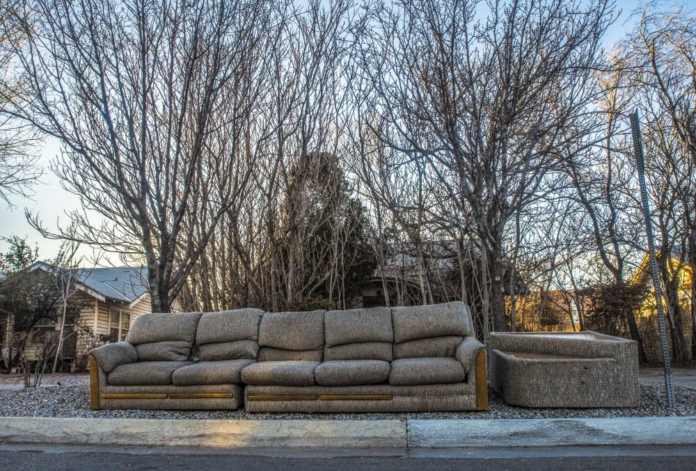 A free couch sits curbside on Stanford Drive and Silver Avenue near Main Campus. Free Stuff ABQ is a Facebook community which thrives on the reuse and recycling of used, unwanted goods.