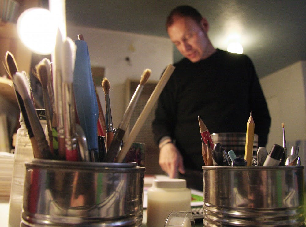 	David Koch, on Tuesday, examines the two images he will show at the Art of Sensuality exhibit at AC2 Gallery. The exhibit explores how we use our senses.