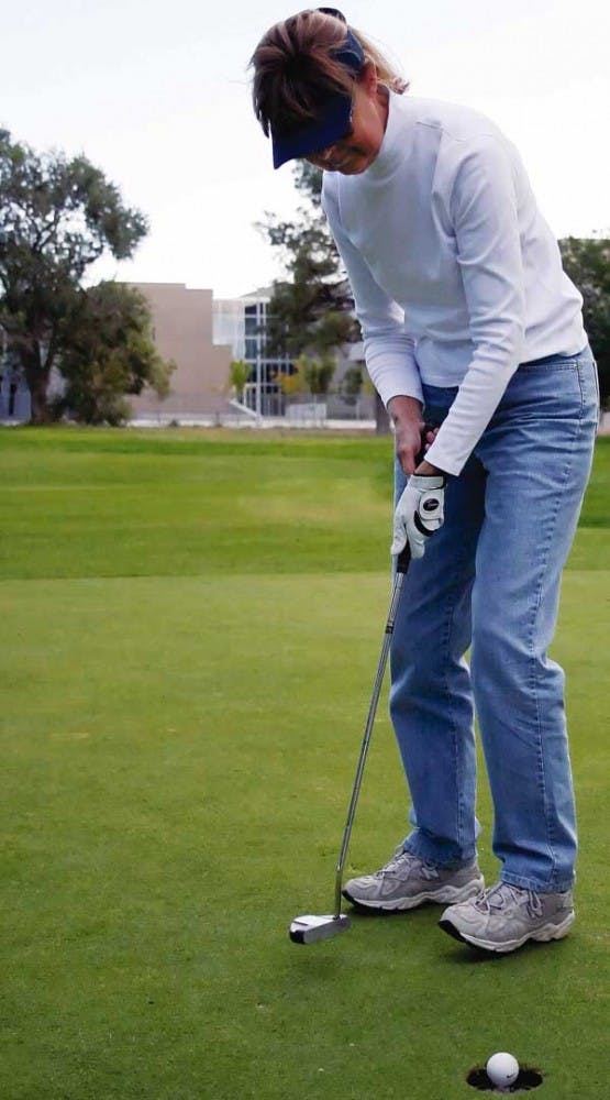 UNM alumna Sharon Loyd putts at the UNM North Golf Course on Tuesday. The  course is the proposed site for a retirement community. 