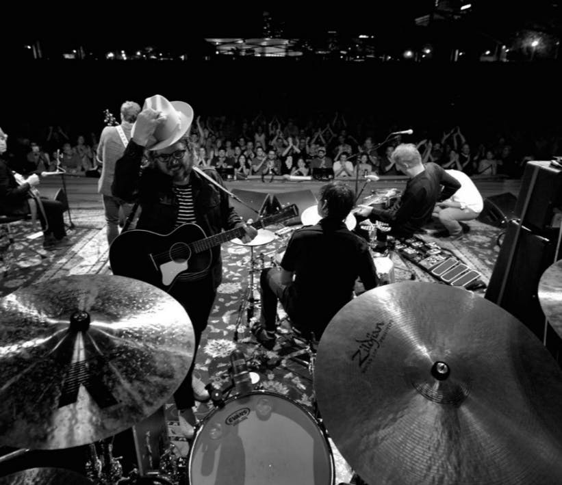Jeff Tweedy tips his hat to drummer Glenn Kochte&nbsp;during a performance at The Chicago Theatre, November 2016