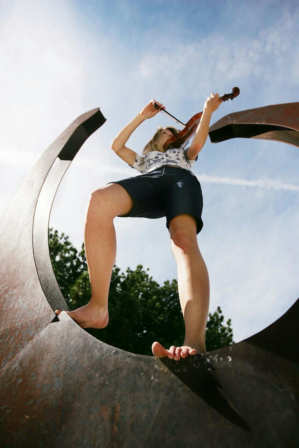 	Renée Hemsing plays the violin in a giant horseshoe on campus.