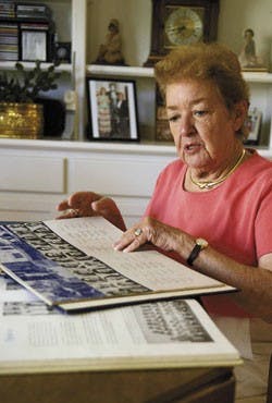 Ellen Ryan, a student at UNM during World War II, looks at a yearbook at her home Tuesday. 