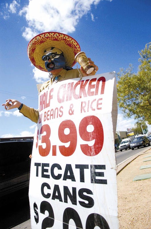 John Voelker wears a sign advertising the Bandito Hideout's specials on Central Avenue on Wednesday.