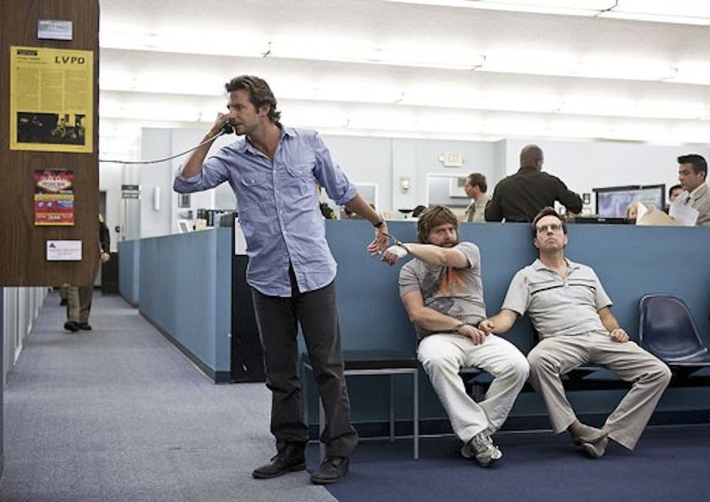 Bradley Cooper as Phil, left, Zach Galifianakis as Alan, center, and Ed Helms as Stu are joined at the wrist by handcuffs in a scene in "The Hangover."