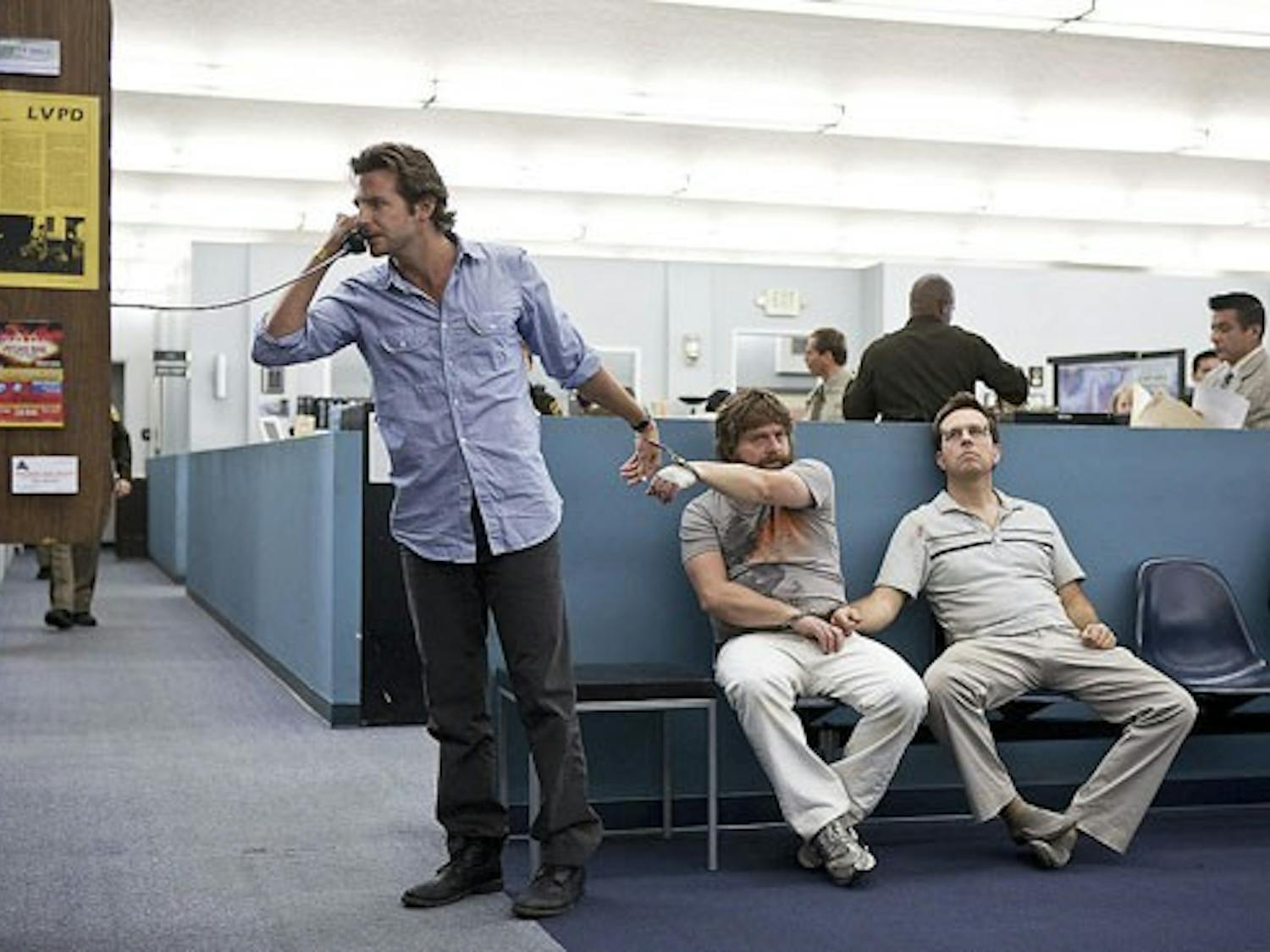 Bradley Cooper as Phil, left, Zach Galifianakis as Alan, center, and Ed Helms as Stu are joined at the wrist by handcuffs in a scene in "The Hangover."