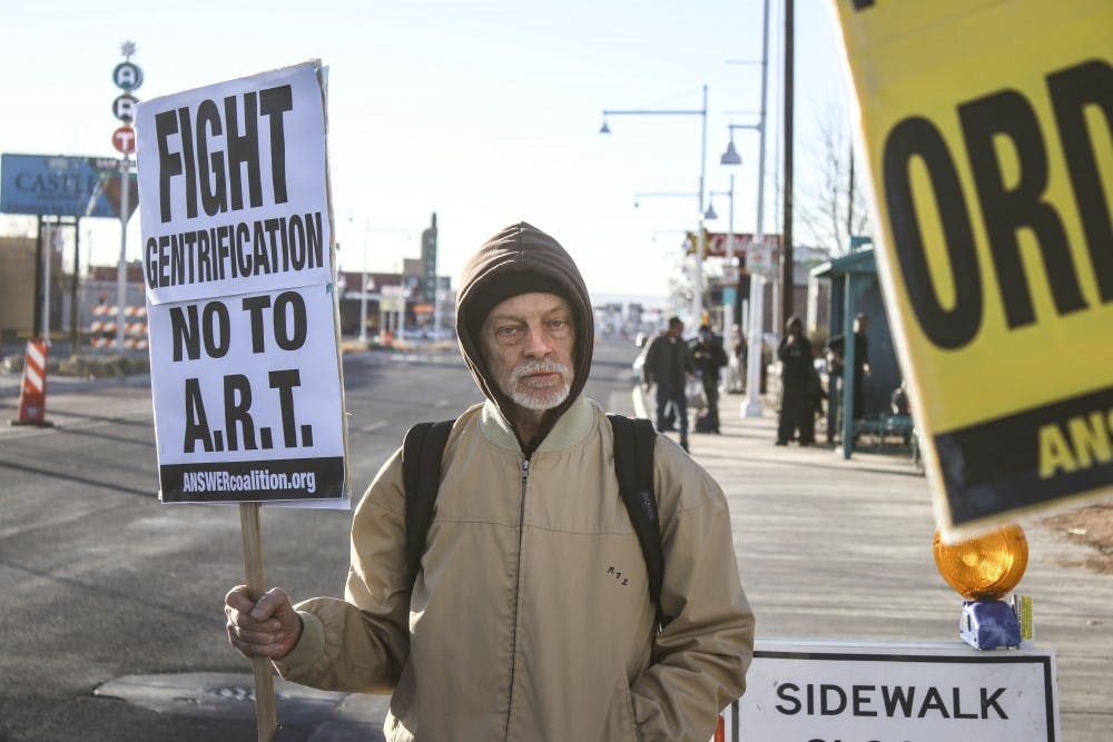 A protester holds an anti-ART sign during the anti-panhandling ordinance protest on the afternoon of Jan. 24, 2017.