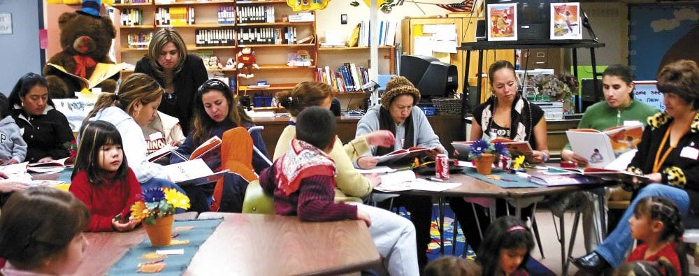 Students, parents and teachers read in the library at Dolores Gonzales Elementary School on Thursday as part of the UNM College of Education's Family Literacy Program.