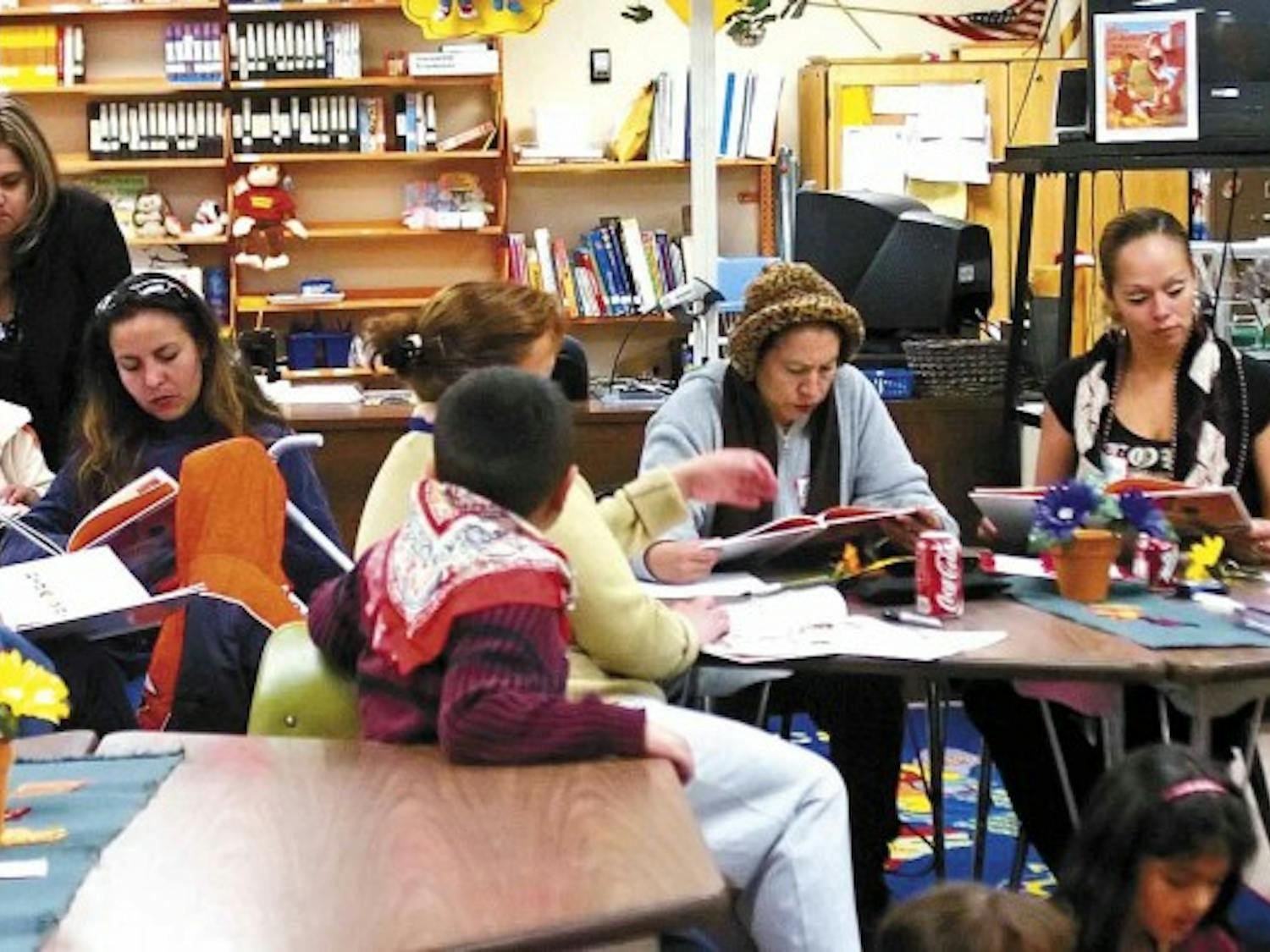 Students, parents and teachers read in the library at Dolores Gonzales Elementary School on Thursday as part of the UNM College of Education's Family Literacy Program.