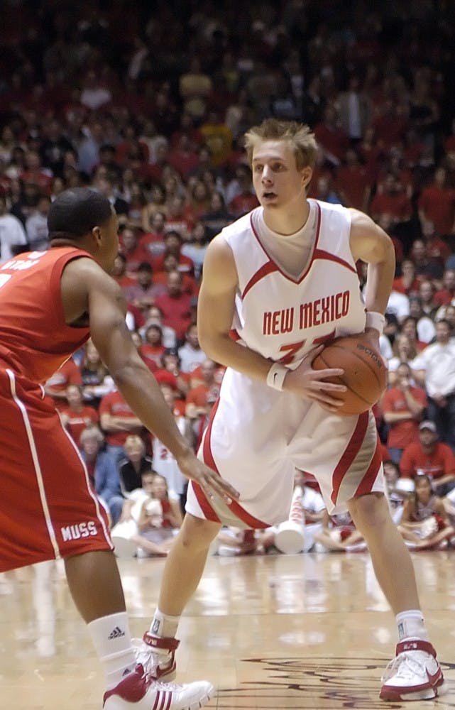 UNM guard Chad Toppert looks to pass the ball while Utah's Johnnie Bryant defends during Tuesday's game at The Pit. Lobos won 77-67. 