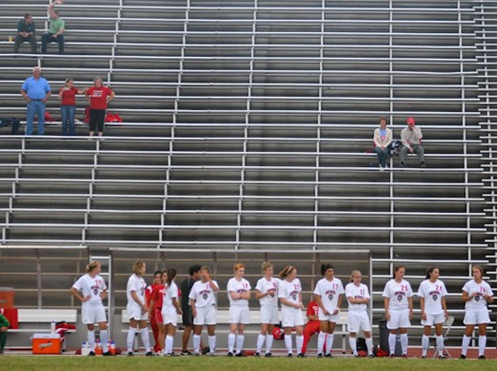 A few fans assemble in the stands for a women's soccer game last Friday. The Lobo Howl Raisers hope to increase the popularity of under-attended sports by offering students prizes for going to games. 