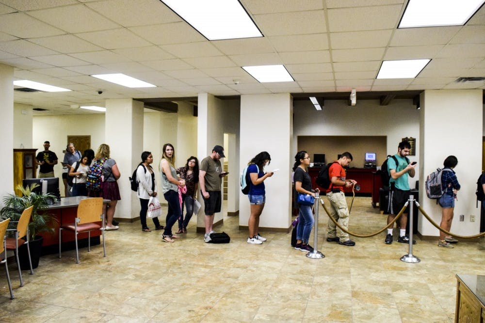 Students wait in line at Student Services to talk with the Bursar's office representatives on Aug. 23, 2017. With the recent strain in tuition at UNM many student's are beginning to feel the strain.&nbsp;