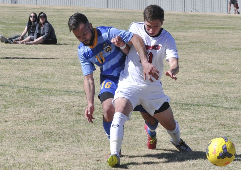 New Mexico midfielder, Wayde Scibilia prevents Fort Lewis player getting the ball in Saturdays game. UNM mens soccer team won the first spring home exhibition of the year with a 4-2 victory. 
