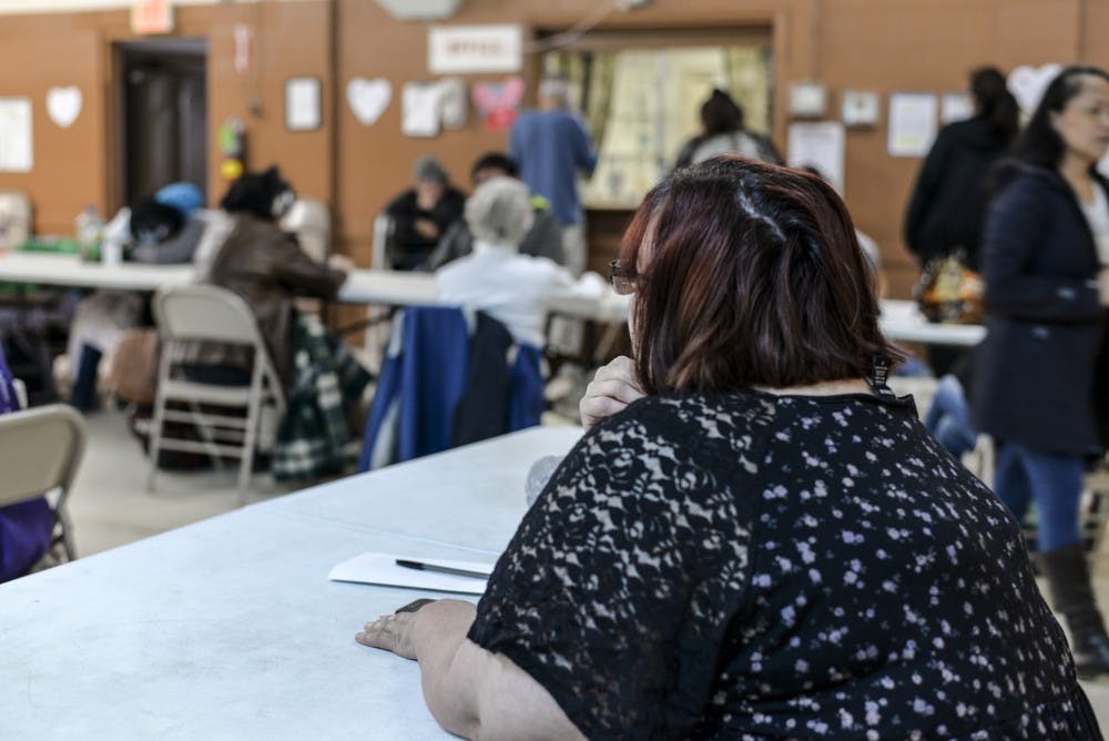 Stephanie Richardson, a resident at Joy Junction since 2015, watches television as other residents wait to use the phone. Richardson takes online college courses and has graduated from Joy Junction’s Christ in Power Program.