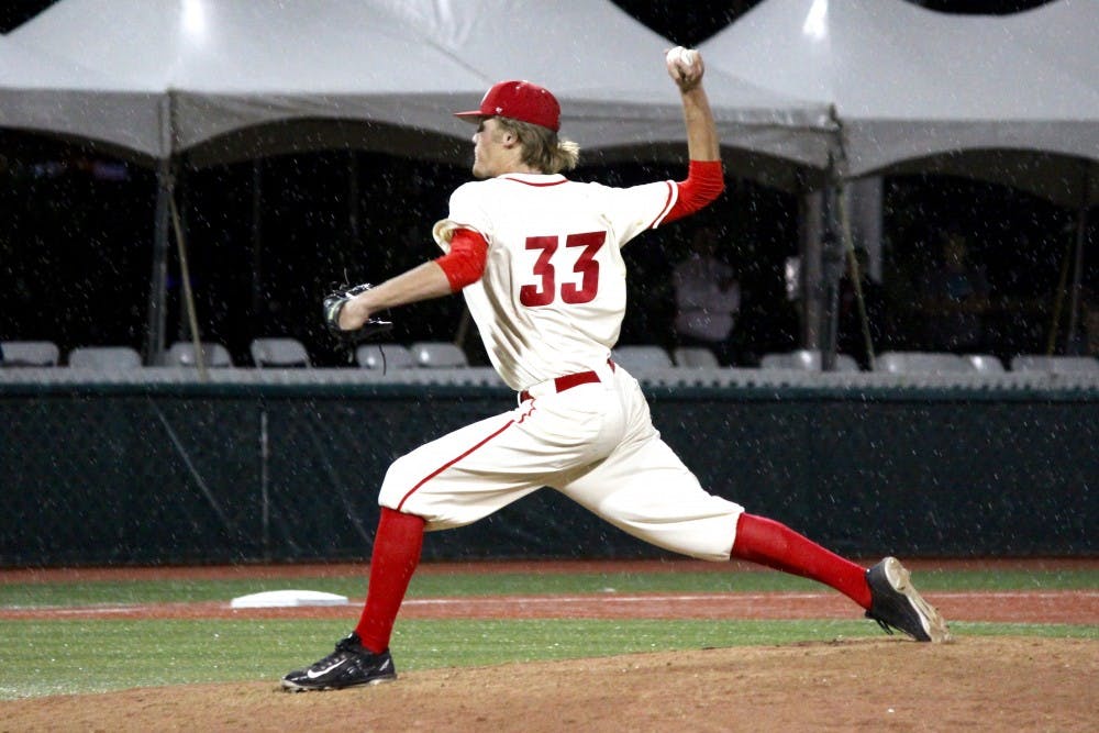 Freshman right handed pitcher&nbsp;Christian Tripp pitches the ball against the Aztecs during a rainy game Friday night at Santa Ana Star Field. The Lobos won at the beginning of the 9th inning 10-5.