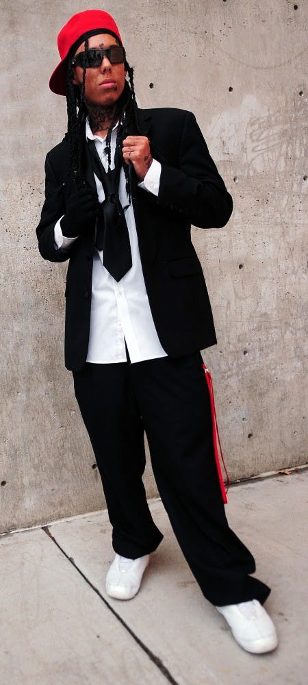 	Marcos Hernandez
Criminology, Freshman

	Hat: Coronado Mall, $15 
Sunglasses: Sunglasses Hut, $130 
Coat: $50 
Shirt: $50 
Tie: $20 
Slacks: $80
Shoes: And1, $100 

	“Be who you are. Be how you are. Dress how you want to dress.” 

	Marcos sports a look near identical to Lil Wayne’s in a public speech about the rapper’s life. Usually, Marcos wears white tank tops and Jordan shorts, but said that Wayne’s fashion stands out because of the star’s ability to blend formal clothing with minute touches, such as the loose tie or baggy slacks, while 
coordinating 
colors.  

