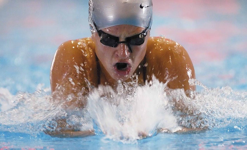 UNM swimmer Andrea Zarins finishes her last lap in the women's 100-yard breaststroke during the last home meet in the Seidler Natatorium on Saturday. 