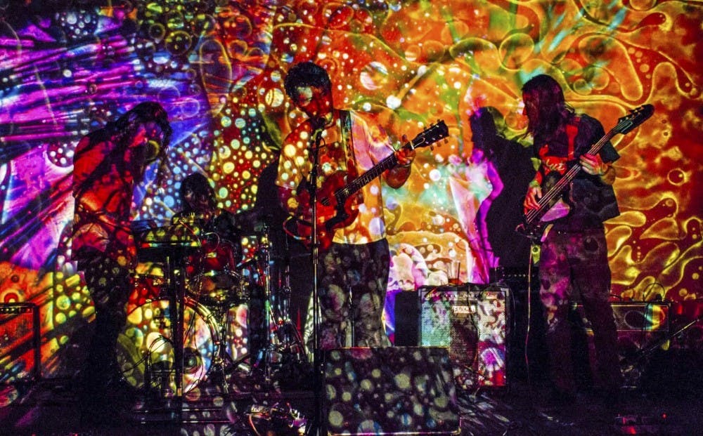 Members of Sun Dog play with a projection cast upon them. Sun Dog is a psychedelic rock band based out of Albuquerque.