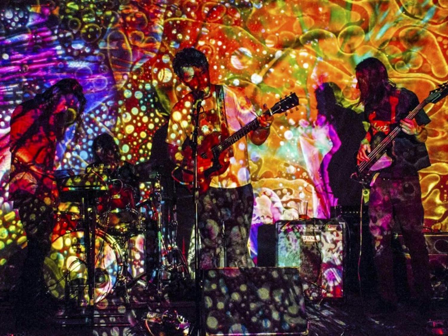 Members of Sun Dog play with a projection cast upon them. Sun Dog is a psychedelic rock band based out of Albuquerque.