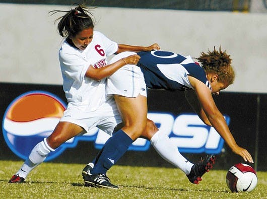 UNM forward Bridgette Sanchez battles for possession with Nevada's Randee Robinson during the Lobos' double-overtime 0-0 tie Sunday.