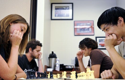 Members of Chess Club from left: Kaley Malban, Alex Resovsky, Eliot Ostling and Anthony Chen play chess in the SUB on Tuesday. Today, two grand chess masters will play a public game against all comers in the SUB.