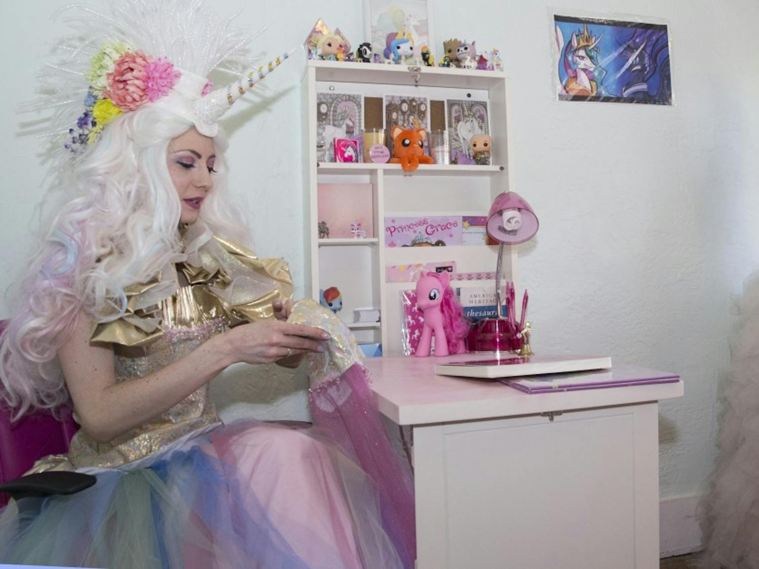Journalism alumna Paula Bauman suits up as Princess Unicorn in her home office Monday afternoon. Princess Unicorn is a persona that Bauman puts on to "inspire and empower" children of all ages during birthday parties and other events.