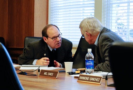 Executive Vice President David Harris, left, speaks with Regent Mel Eaves before a meeting of the Finance and Facilities Committee on Thursday.
