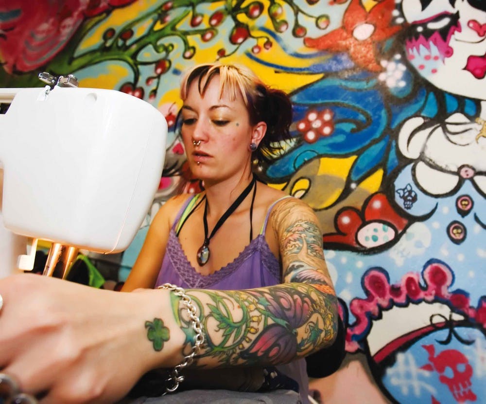 Cutie Pie owner and seamstress Betty Wyatt makes a shirt at her store at 1417 Central Ave. N.E. on Friday.