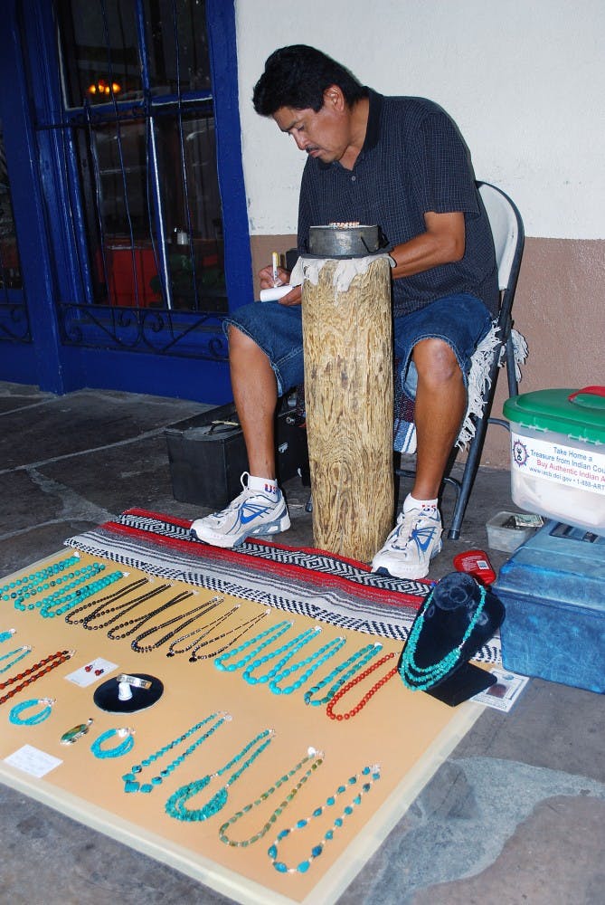 	Curtis Platero works on a jewelry piece in Old Town on July 25. An amendment went into effect on the state Indian Arts and Crafts Amendments Act that reduces the minimum stolen property value required for a felony from $20,000 to $500.