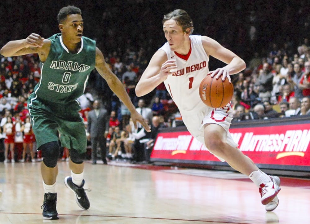 Lobo sophomore guard Cullen Neal, right, attempts to pass Adams State junior guard Travante Williams, left, during the basketball exhibition game against Adams State at the Pit on Friday night. The Lobos will be hosting Idaho State tonight at 8 p.m.