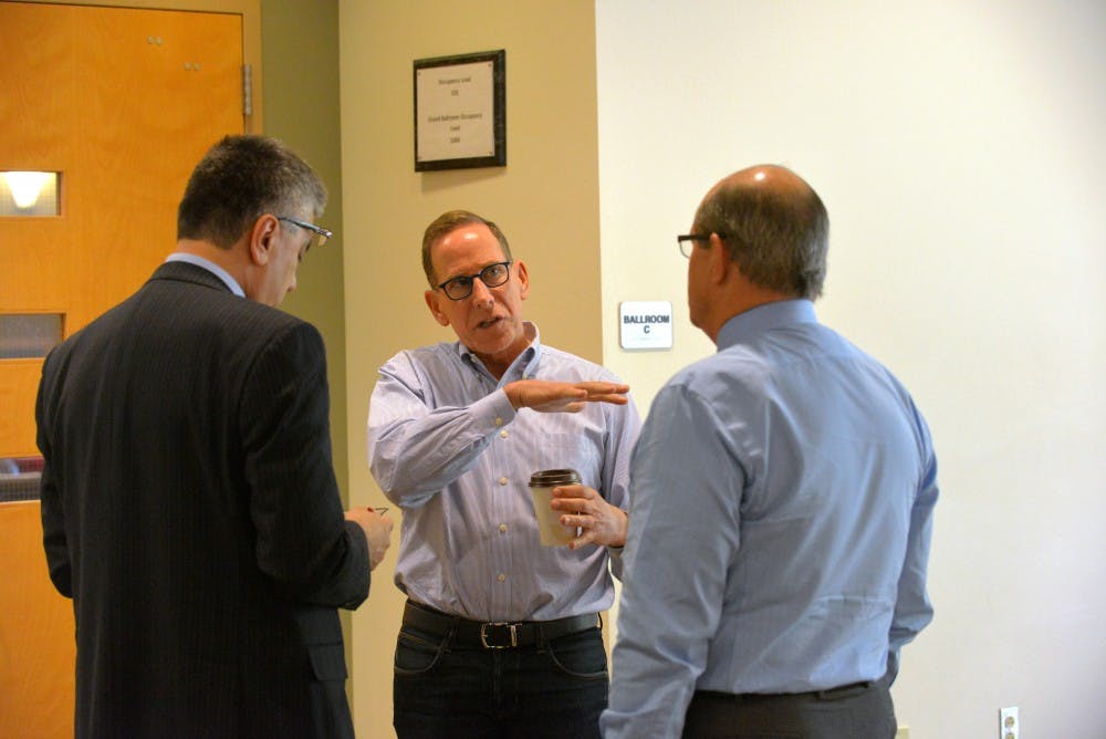 Greg Horowitt (center), a co-founder of T2 Venture Creation, talks with provost Chaouki Abdallah and UNM's President Robert Frank outside the SUB. The Rainforest 2: UNM Economic Development Summit was held at the SUB ballroom Monday Oct. 26, 2015.&nbsp;