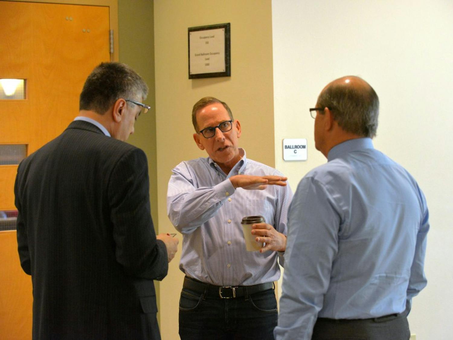 Greg Horowitt (center), a co-founder of T2 Venture Creation, talks with provost Chaouki Abdallah and UNM's President Robert Frank outside the SUB. The Rainforest 2: UNM Economic Development Summit was held at the SUB ballroom Monday Oct. 26, 2015.&nbsp;