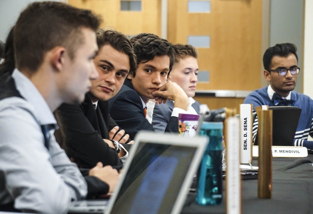 UNM Senators T. Pitone-Aufrichtig, left, and D. Sena discuss a proposed bill that would change the ASUNM election process in the SUB ballrooms on Sept. 27, 2017. 