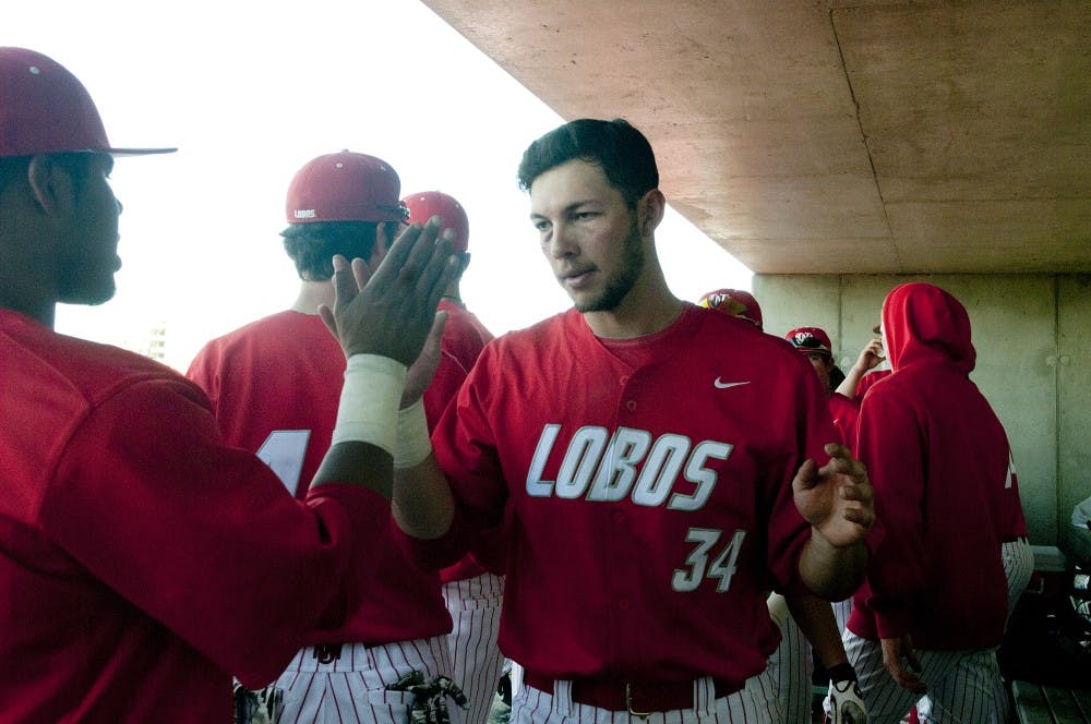 	First baseman Ryan Padilla gives his teammates a high-five during the Northern Illinois game on Sunday. The Lobos defeated Missouri State 7-0 then tied Northern Illinois 3-3. It was UNM’s first tie since 2004 against Northwestern.