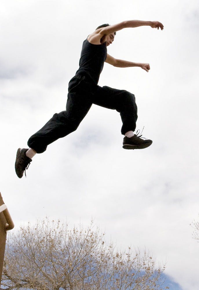	Parkour runner Zackery Wright leaps over a stairwell near Johnson Gym on March 7. Wright has done parkour for more than three years.