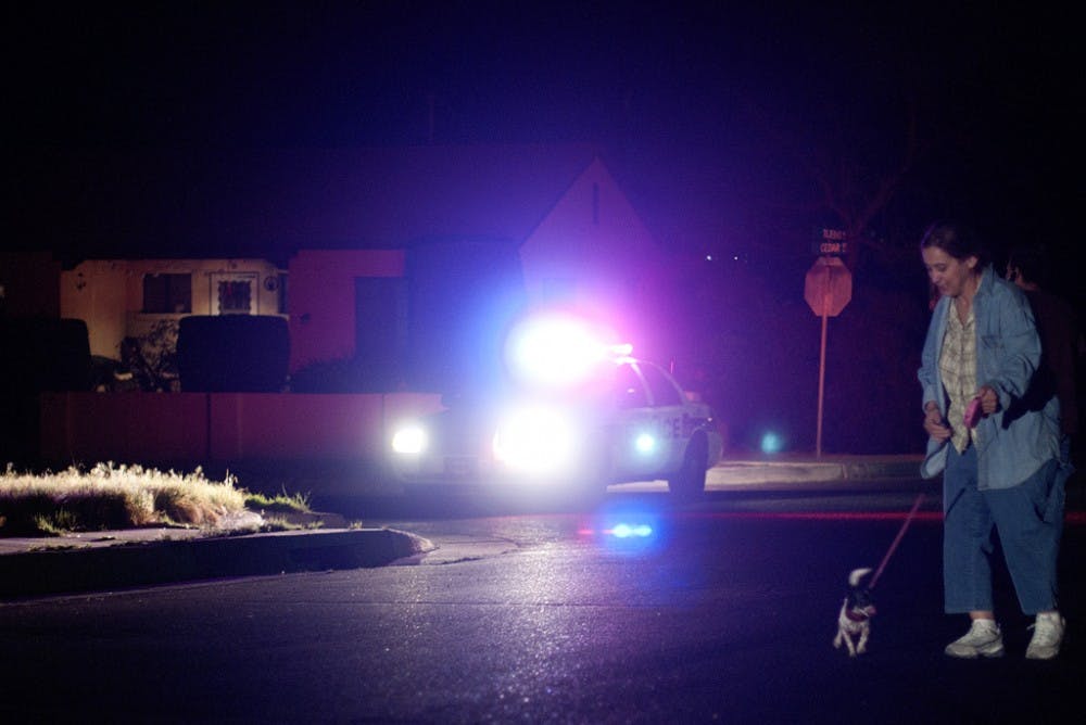 	Trish Montoya walks her dog Isabeau as police investigate an alleged homicide that occured in an alleyway off of Tijeras and Cedar Street NE. Montoya lives across the street from where the alleged homicide occured. “I think this was more of a random act of violence,” Montoya said, “I don’t feel like I have a reason to feel any less safe.”