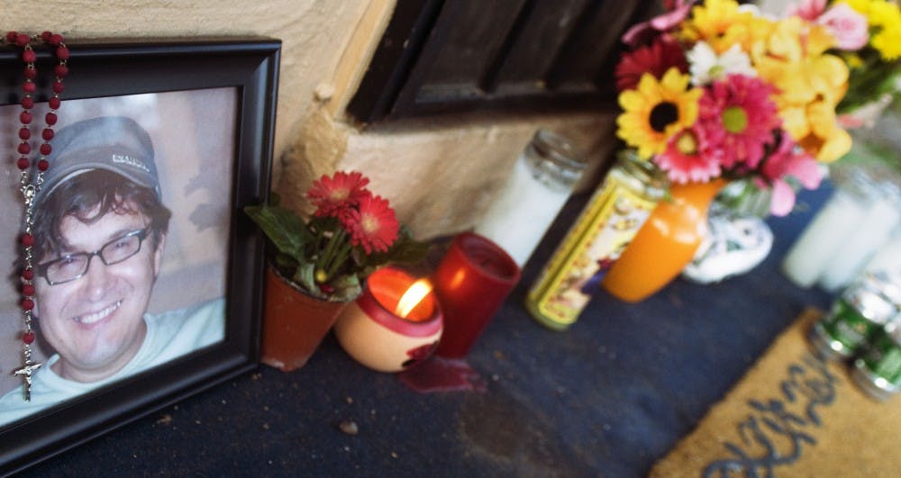 	Friends of Hector Torres left candles and other items at a memorial on his front porch on Santa Monica Avenue.