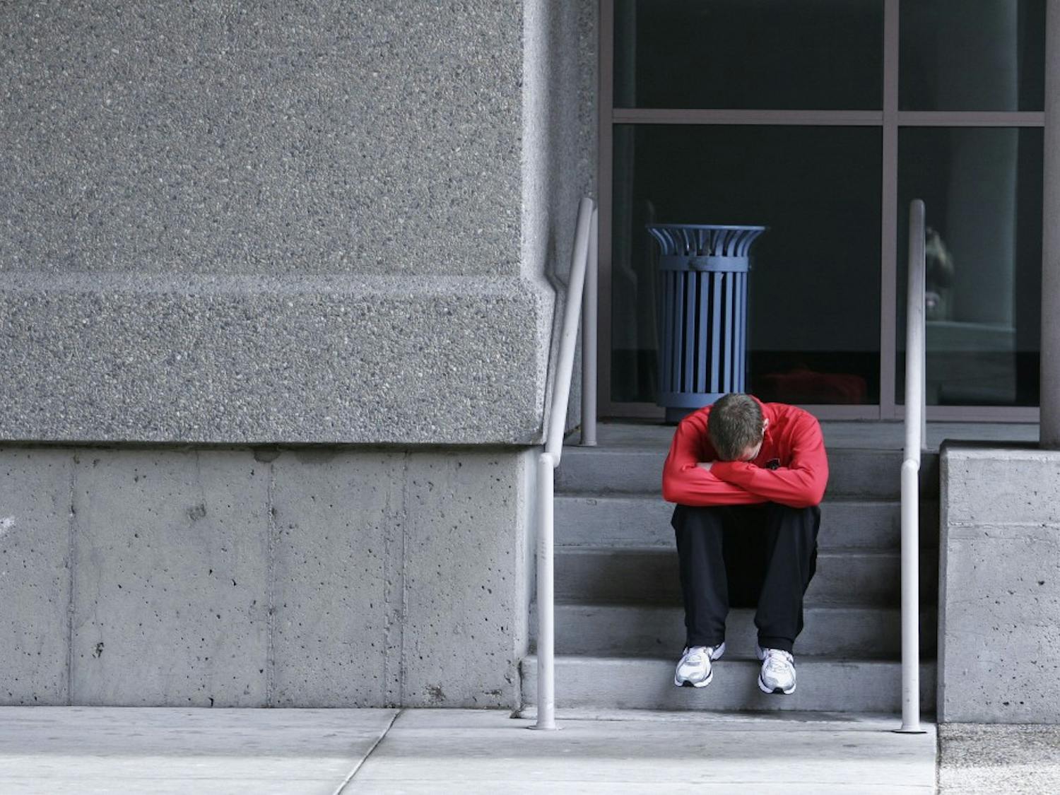Lee Emanuel sits dejectedly after coming in third place in the 800-meter run nals on Saturday at the Albuquerque Convention Center.