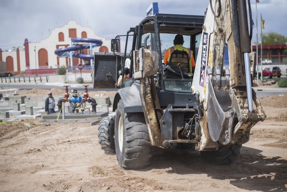 Construction workers lay the foundation for Green Jeans Farmeries retro fitted shipping containers on April 17. Issues regarding certain permits has halted the grand opening of Green Jeans Farmery.