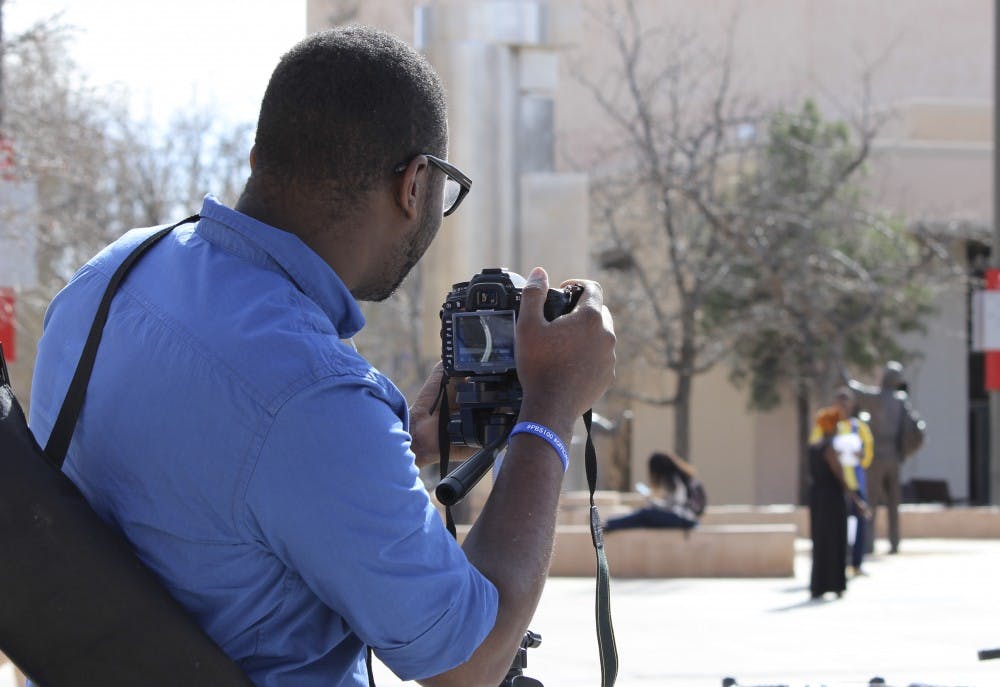 Allan Stone, a videographer with the Black Student Union, records fellow BSU colleagues enacting a staged scenario Thursday afternoon in front of the SUB. The Black Student Union aims to bring awareness to racial issues affecting minorities.